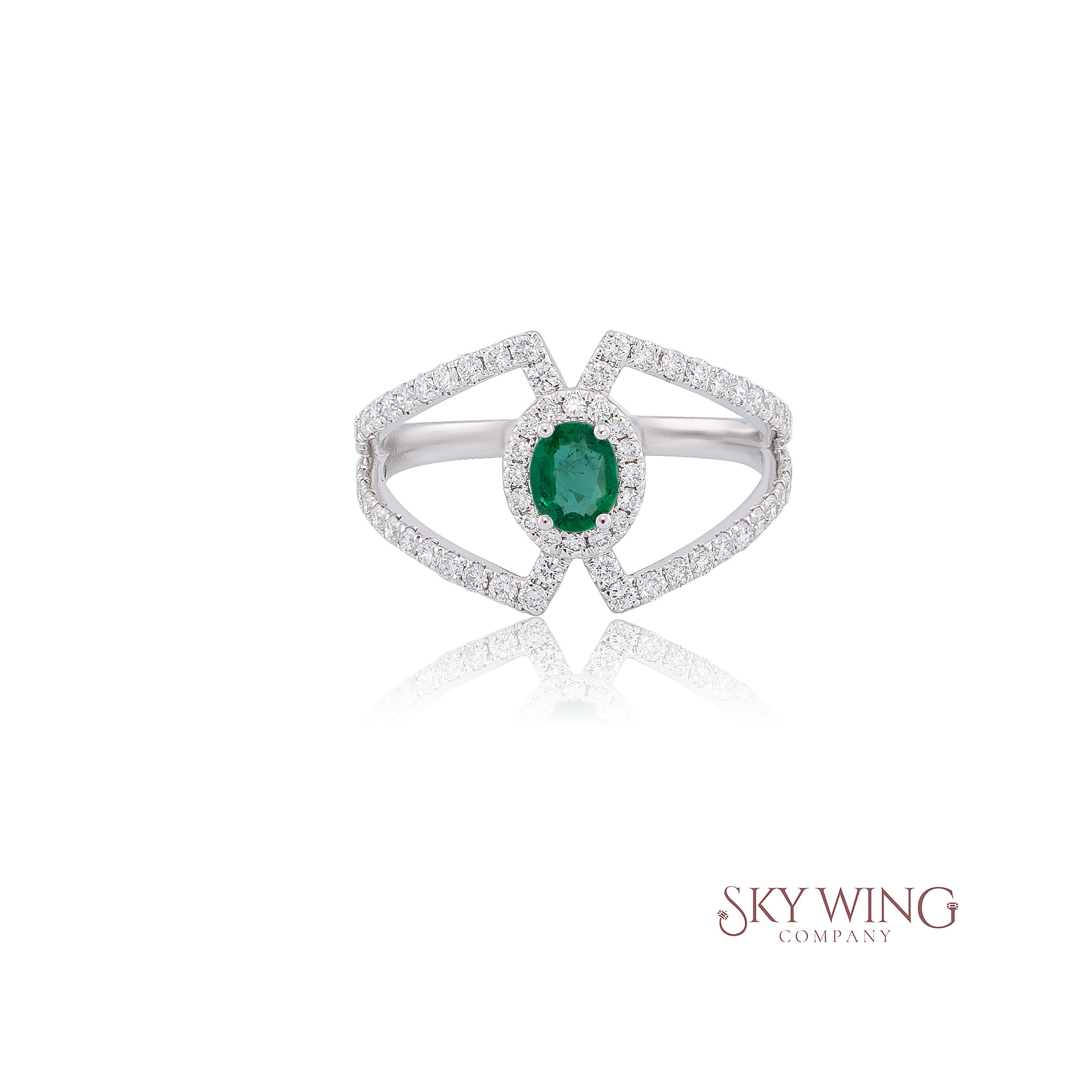 OVAL EMERALD AND ROUND DIAMOND RING