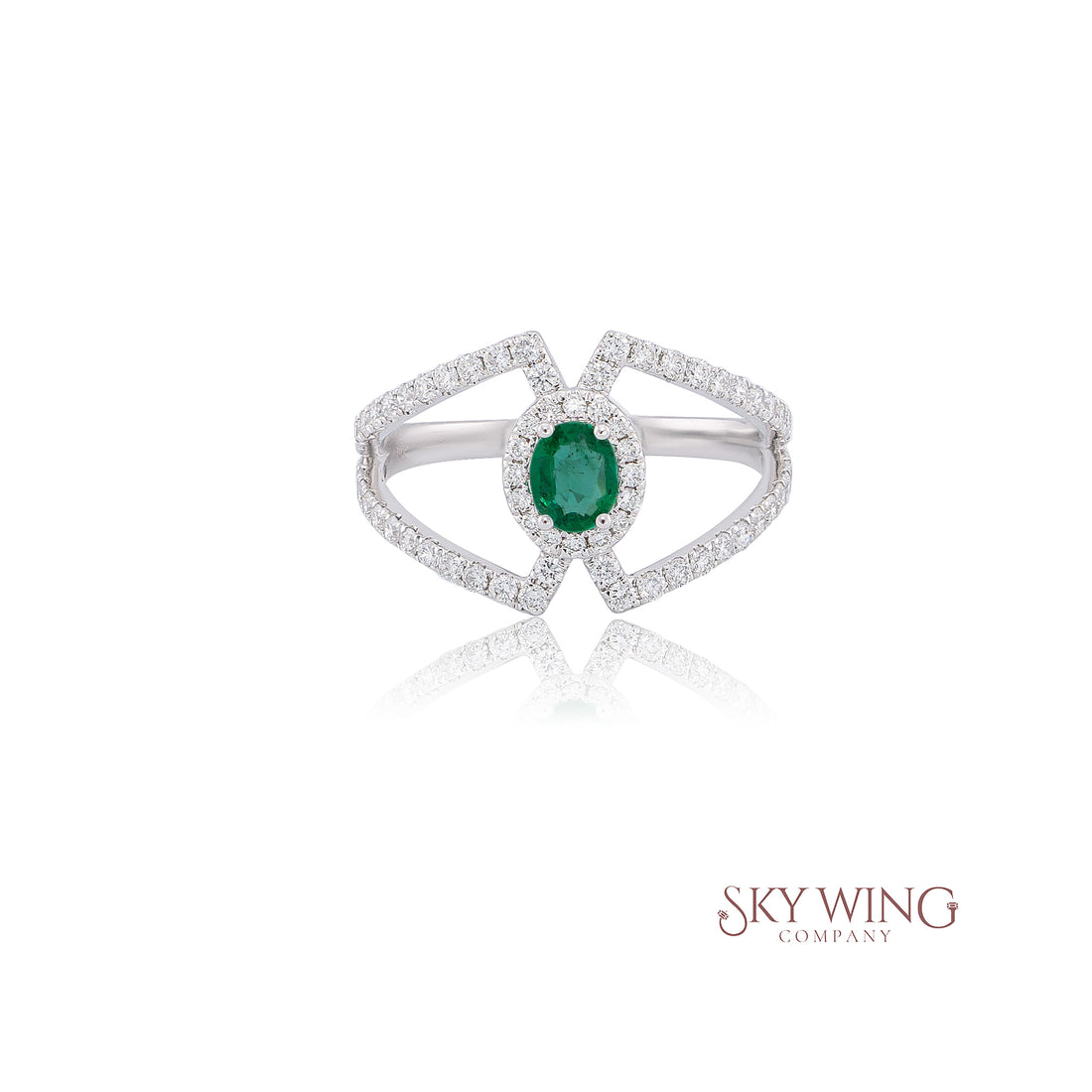 OVAL EMERALD AND ROUND DIAMOND RING
